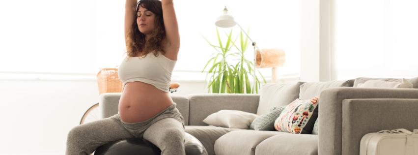 A pregnant woman doing prenatal yoga or light exercise in a serene, natural setting.