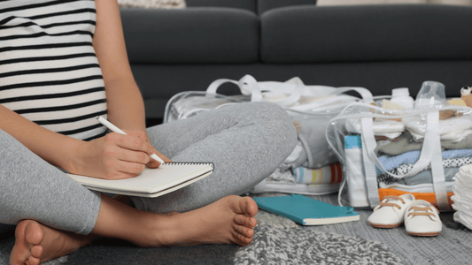 Mum sitting on bed with packed hospital bag