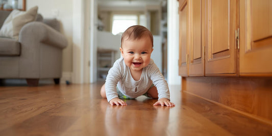 baby crawling on living room floor with cabinet locks visible