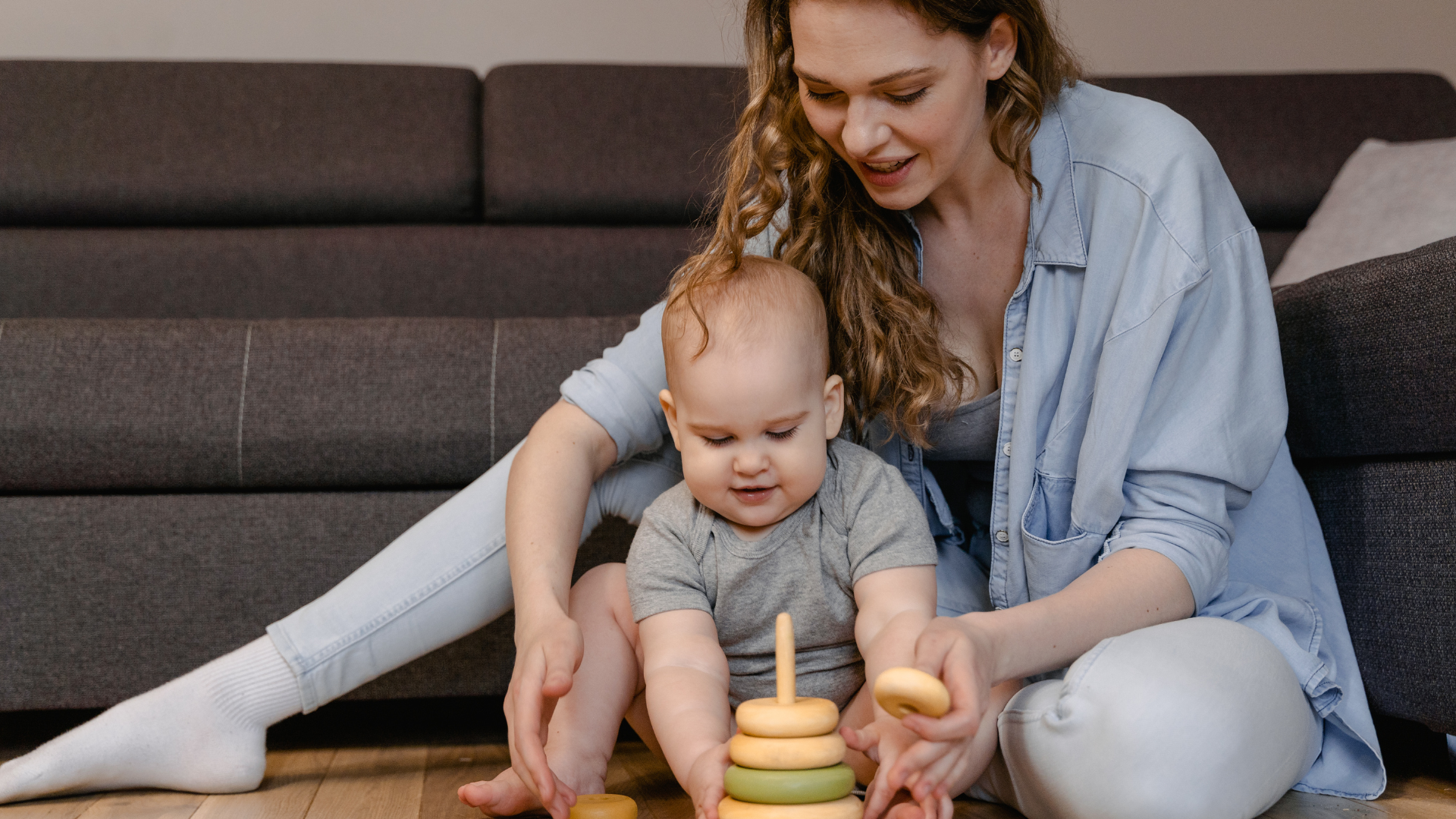 Mum playing a dougnut game with her baby