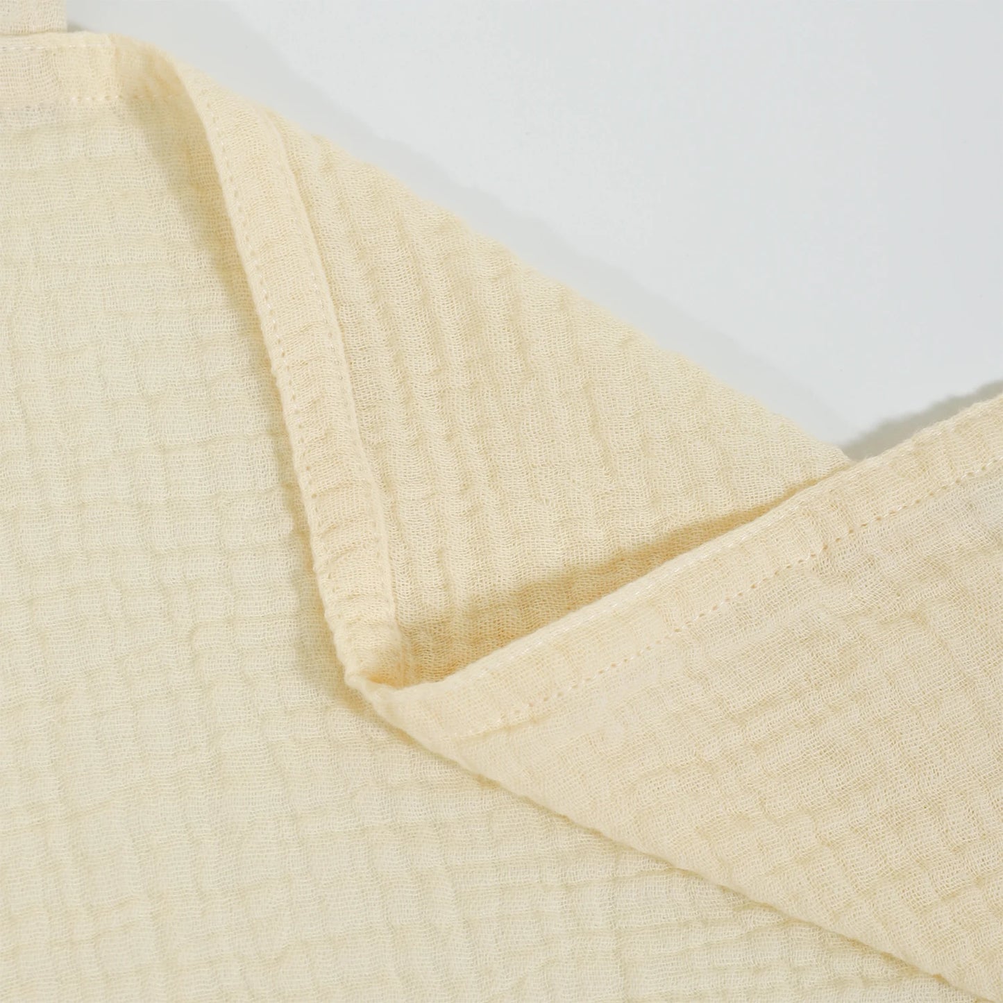 Close-up of a beige textured fabric on a light gray background
