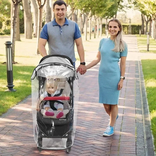 Man and woman walking with a stroller in a park