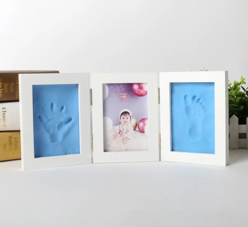Three white photo frames with blue handprint and footprint on a white surface, with 'Morning Baby Store' text above.