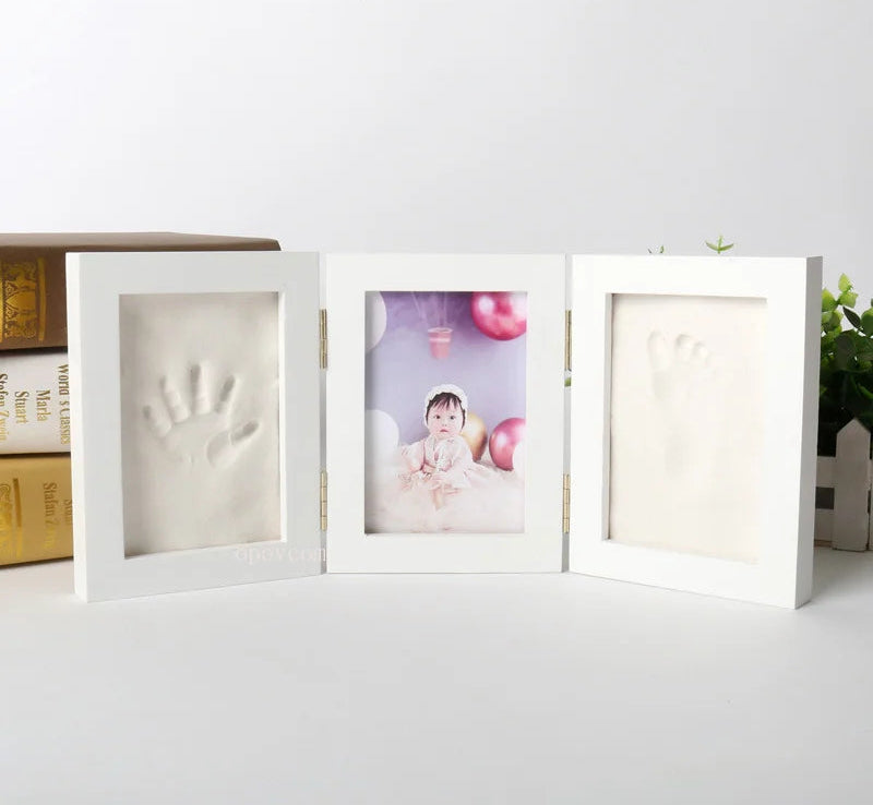 White photo frame with baby handprint and footprint on a white surface, with 'Morning Baby Store' text above.