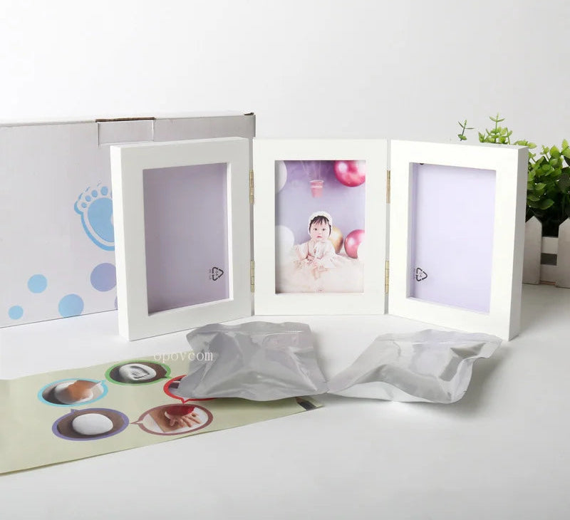 White three-panel photo frame on a white surface with a baby picture inside, branded 'Morning Baby Store'.
