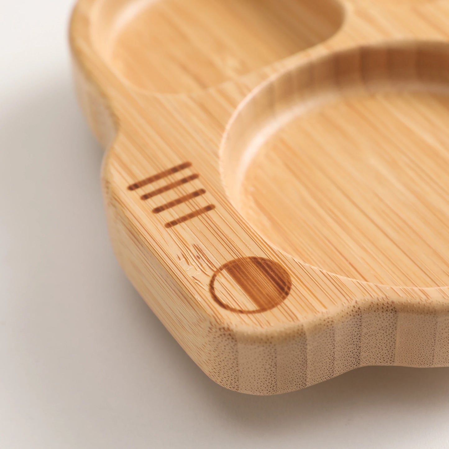 Wooden cutting board with a heart-shaped design on a light background