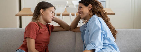 A candid photo of a pregnant woman or new mom sharing her story, possibly in a home setting.