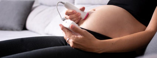 A display of pregnancy accessories like a pregnancy journal, gel for doppler, headphones, and portable speakers.