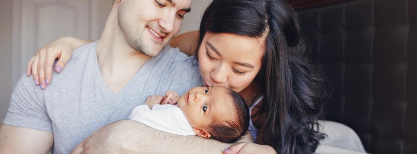 A happy family with their newborn baby, showcasing a joyful and successful pregnancy journey.