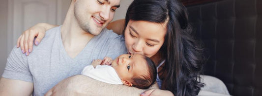 A happy family with their newborn baby, showcasing a joyful and successful pregnancy journey.