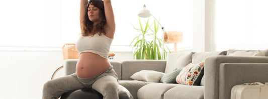A pregnant woman doing prenatal yoga or light exercise in a serene, natural setting.