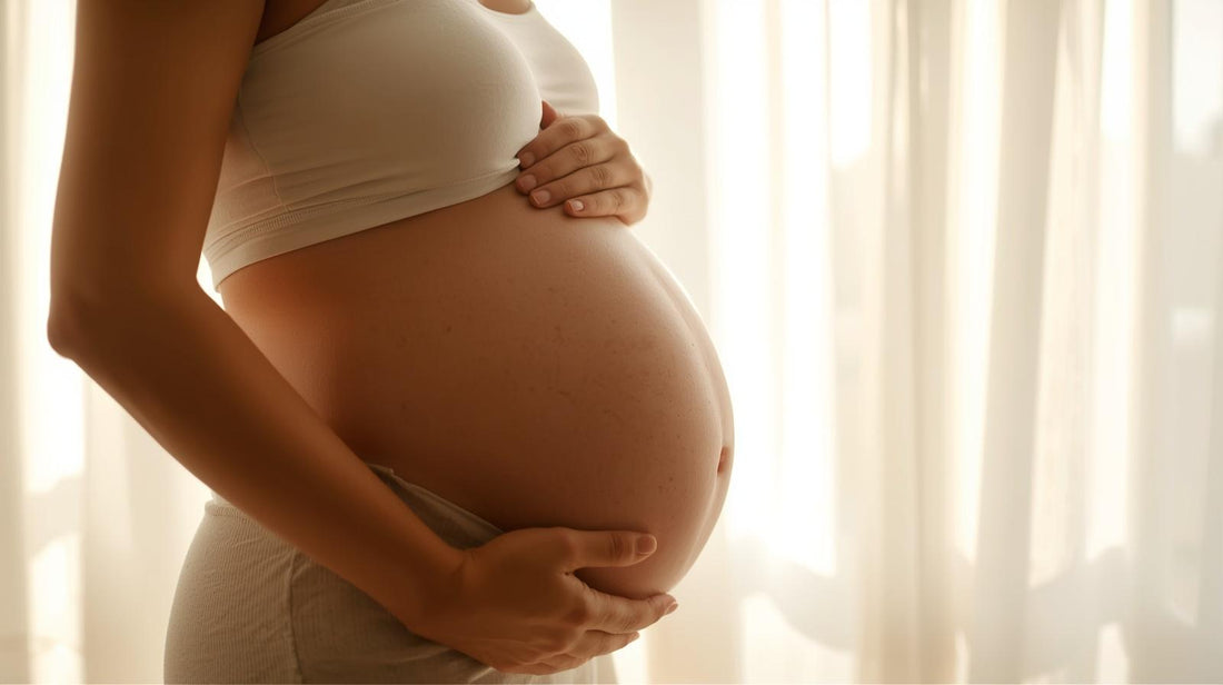 Third trimester image of a pregnant woman holding her belly
