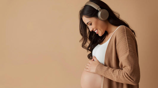 pregnant mum wearing headphones and smiling at her bump