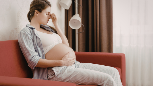 woman sitting with slight discomfort