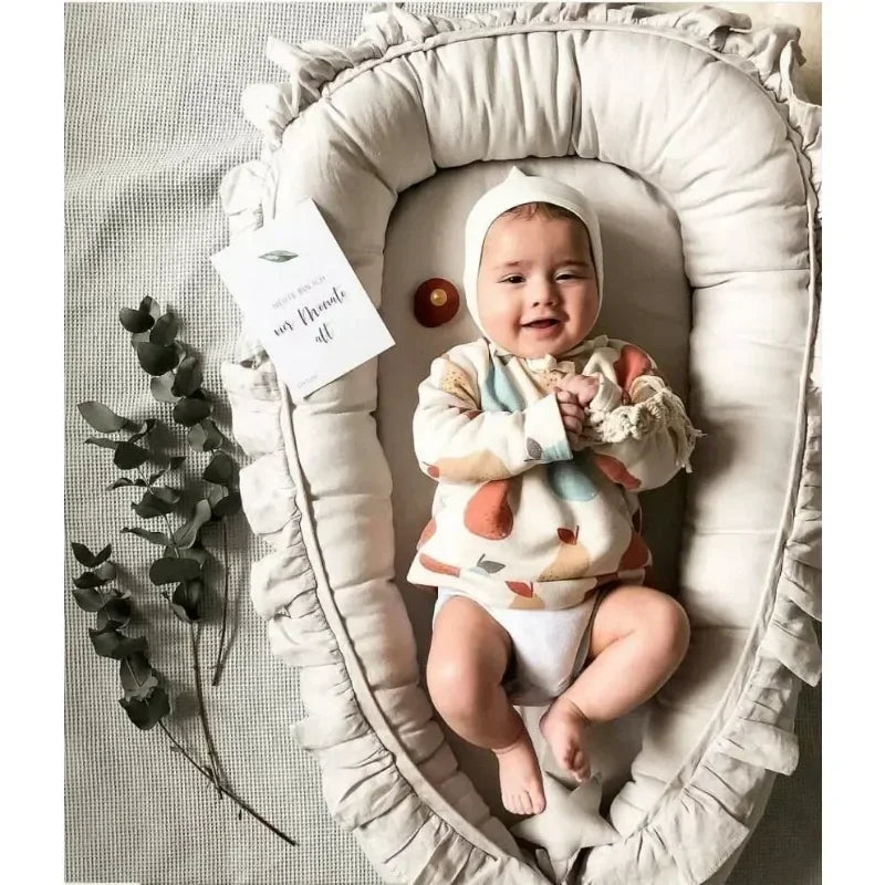 Baby laying in mamas bump Portable Baby Nest – Soft Sleep Pod for Newborns & Travel