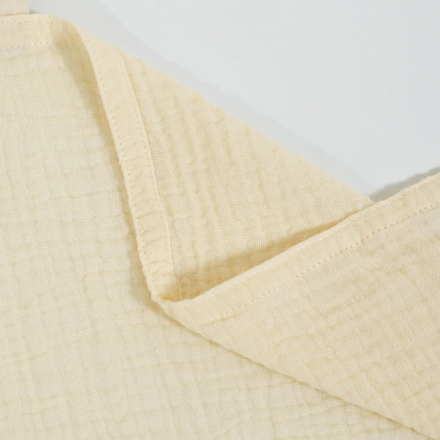 Close-up of a beige textured fabric on a light gray background