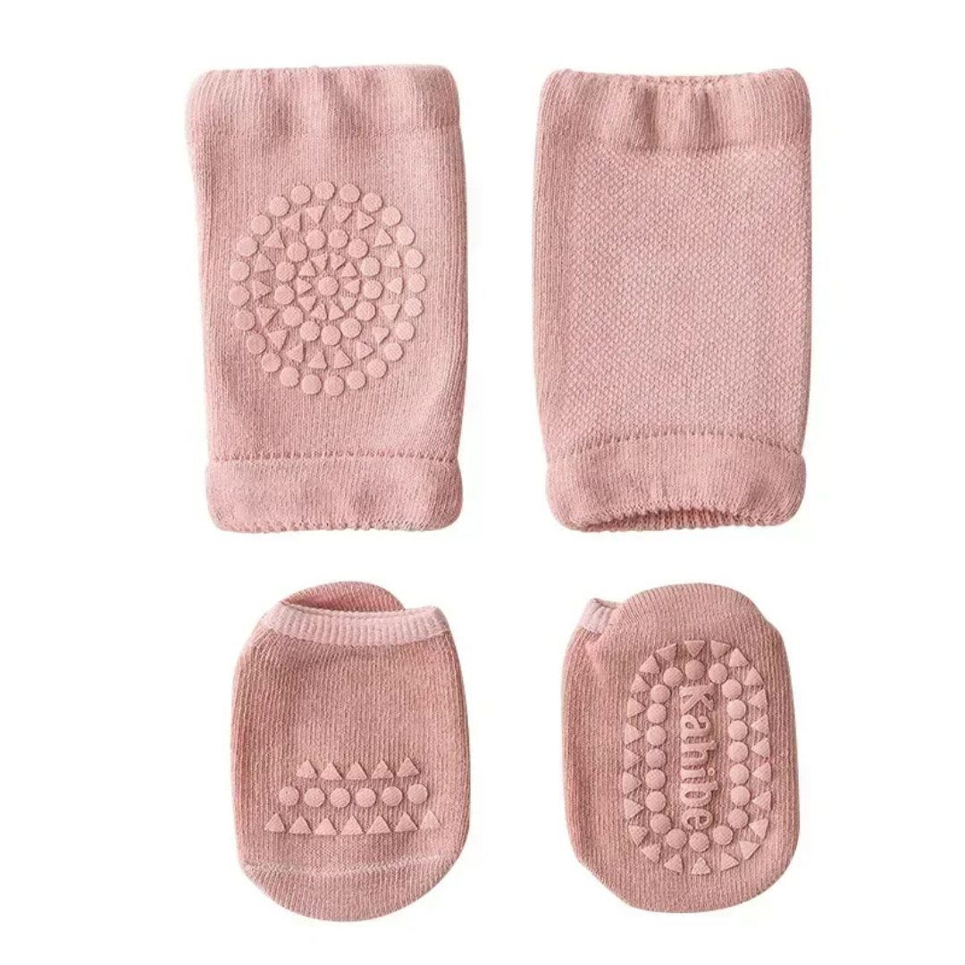 Set of pink baby socks with textured sole on a white background
