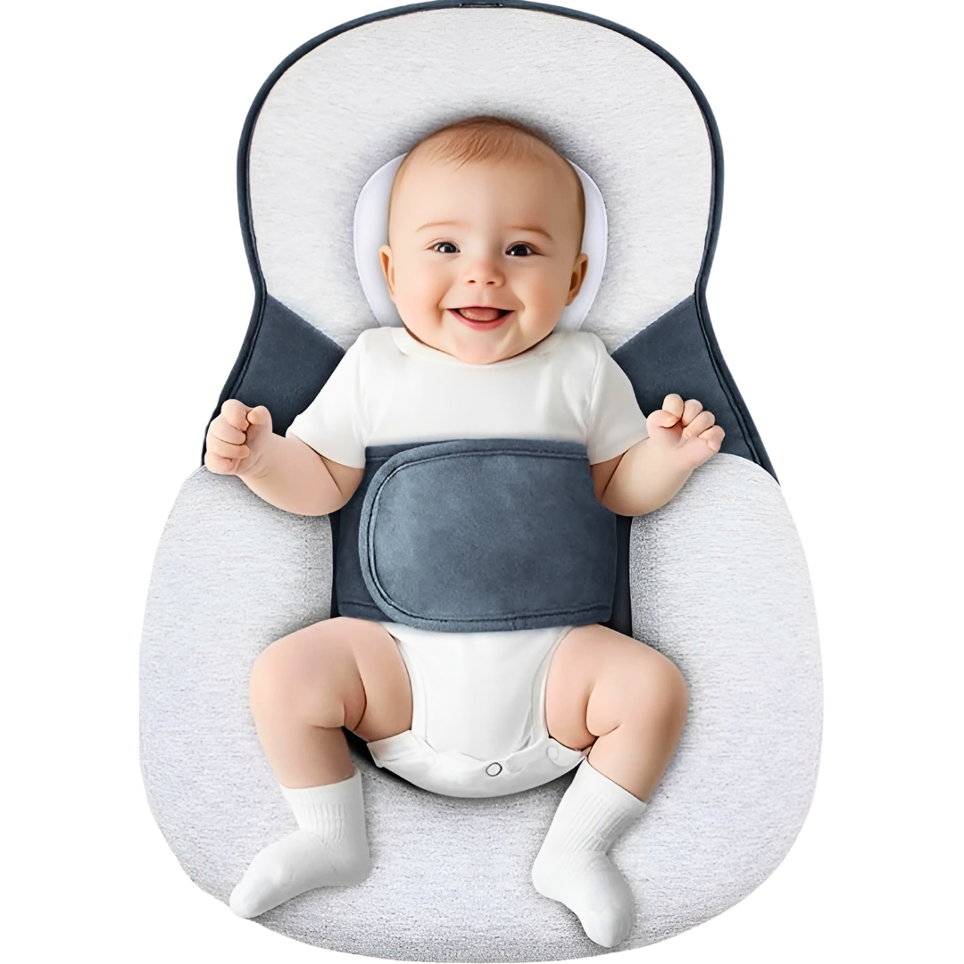 Baby sitting in a gray and white baby seat with a white background