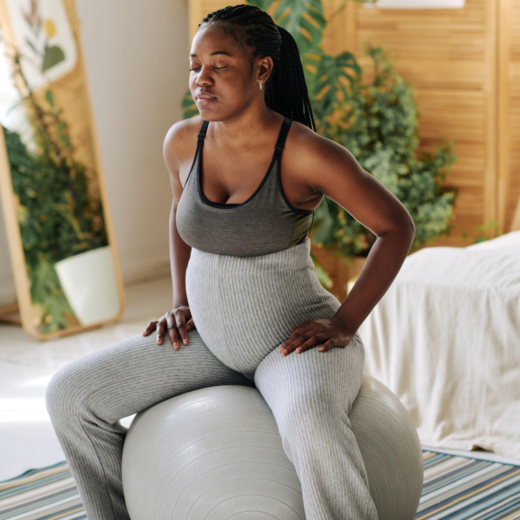 Pregnant Woman Sitting on a Grey Birthing Ball