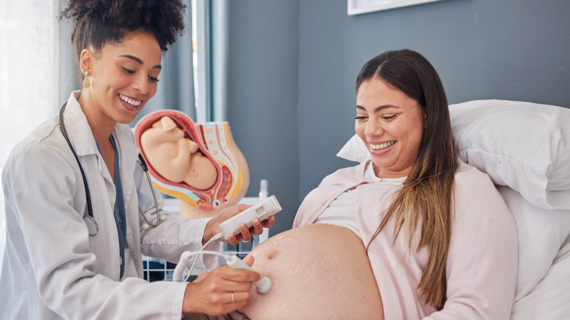 Midwife using the fetal doppler on a mother for the first time