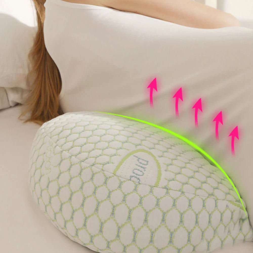 Pregnant woman laying on a u-shaped pillow