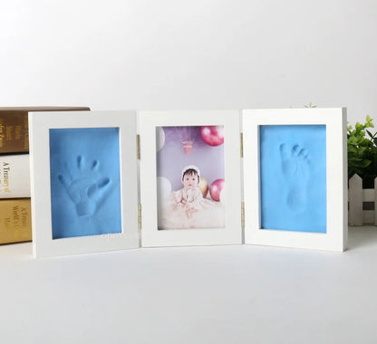Three white photo frames with blue handprint and footprint on a white surface, with 'Morning Baby Store' text above.