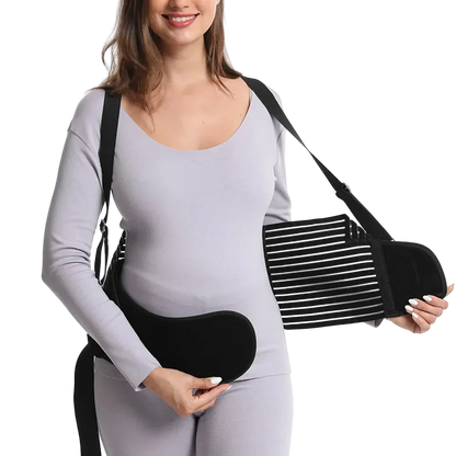 Woman wearing a black sling on one arm against a white background