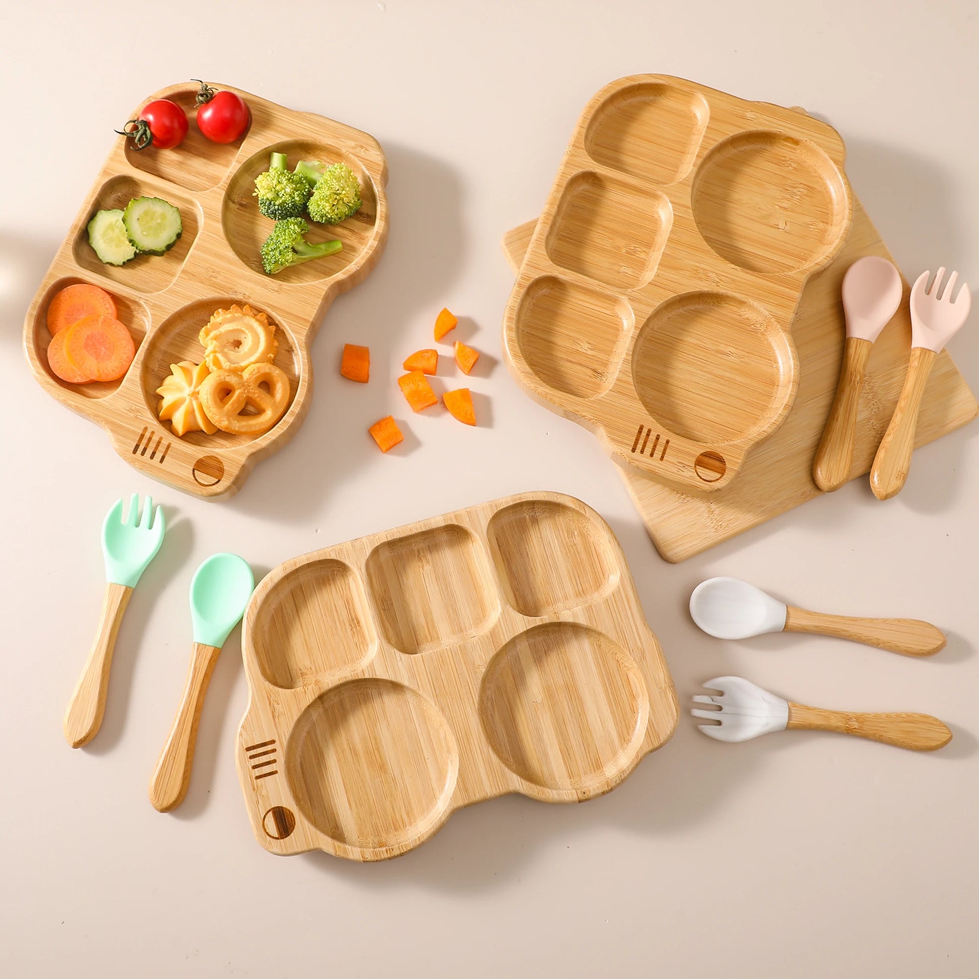Wooden children's plates and utensils with vegetables on a beige background