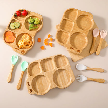 Wooden children's plates and utensils with vegetables on a beige background