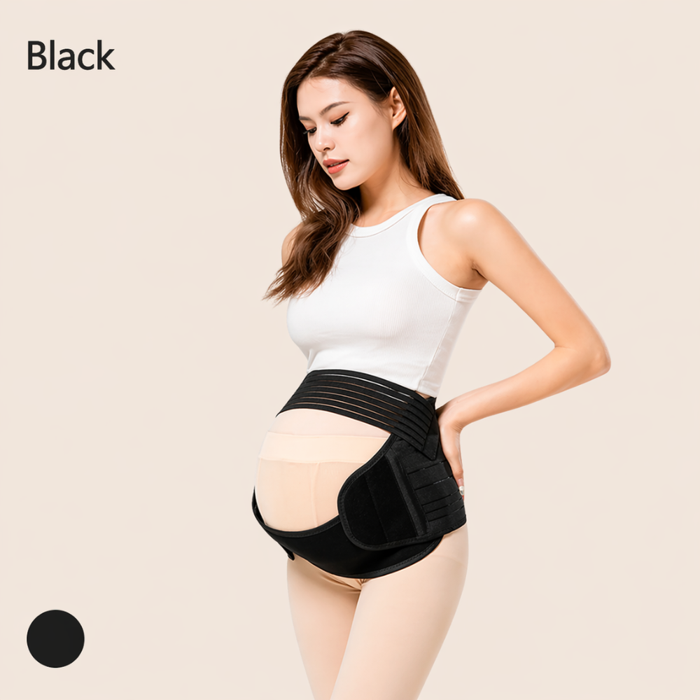 A woman wearing a black long-sleeve top and black leggings with a black Mama's Bump Essential maternity support belt displayed against a beige background.