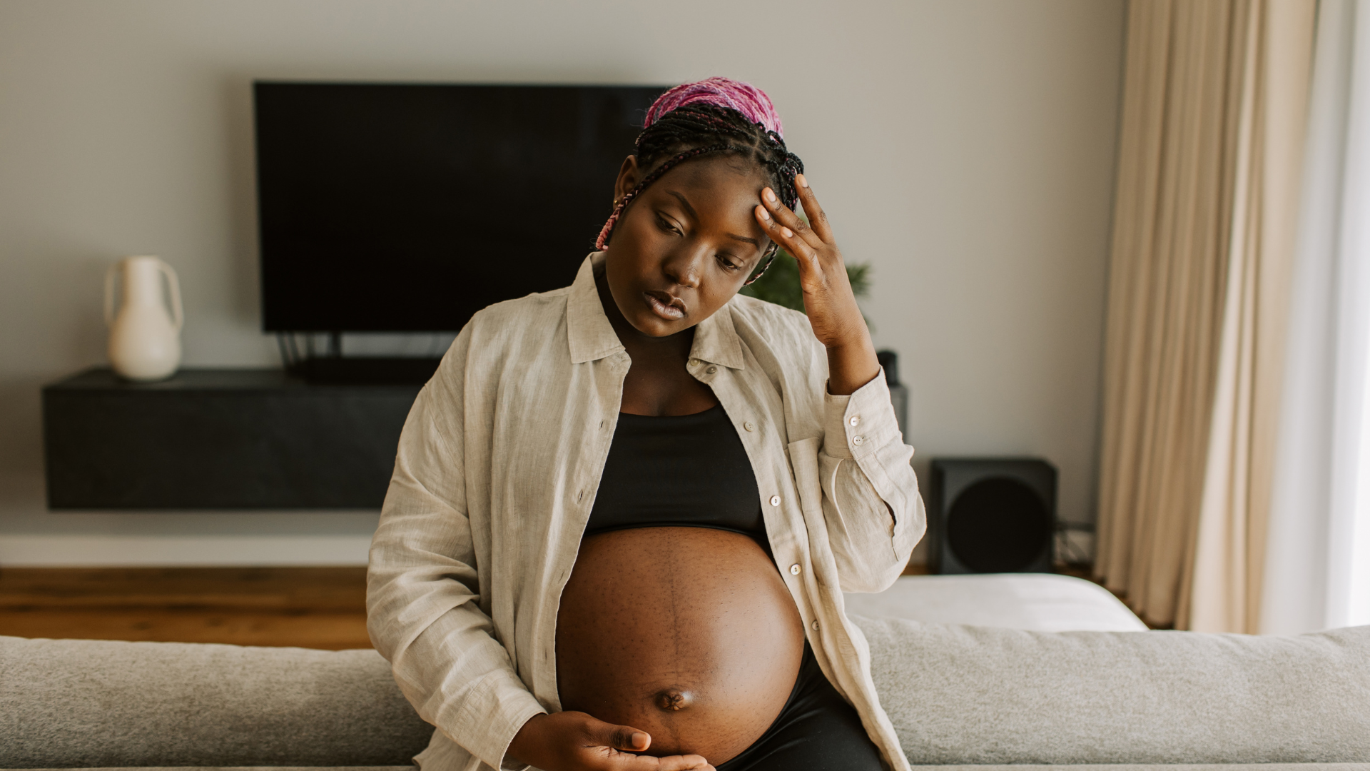 Pregnant woman in deep thought about pregnancy gear essentials