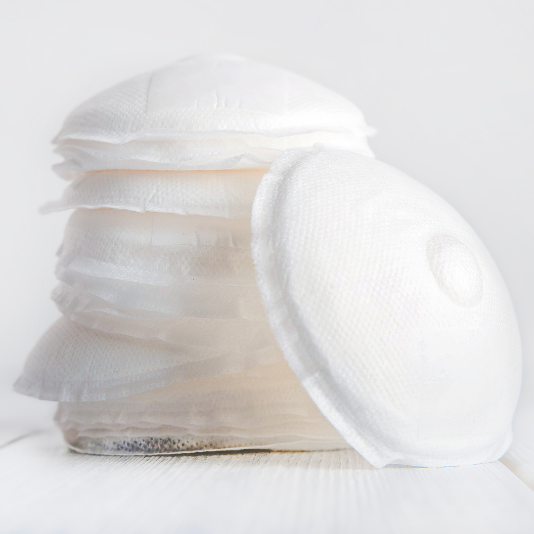 Close-up of a roll of white fabric on a light gray background